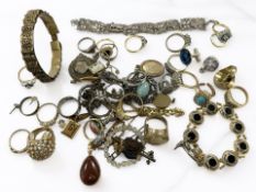 A collection of dress rings, an eastern white metal panel bracelet,