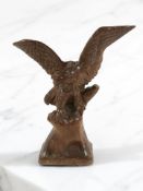 A carved wooden statue of an eagle without stretched wings, height 27 cm.