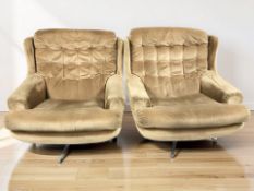 A pair of 20th century swivel lounge armchairs in buttoned upholstery, width 92 cm.