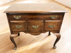 A reproduction walnut four drawer low boy in the George II style, 84 cm x 45 cm x 77 cm.
