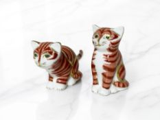 Two Royal Crown Derby seated cat paperweights with gold stoppers.