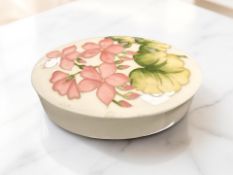 A Moorcroft oval trinket box and cover, width 13 cm.
