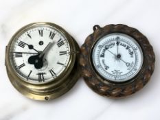 A carved oak rope twist framed aneroid barometer, diameter 20 cm,