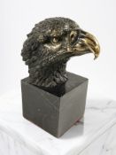 A reproduction bronze eagle's head bust, on marble plinth, height 22 cm.