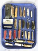 A group of Swiss army knives and other folding pocket knives.