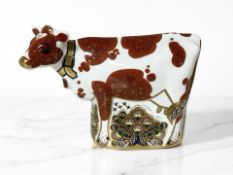 A Royal Crown Derby Daisy Cow figure, gold stopper.