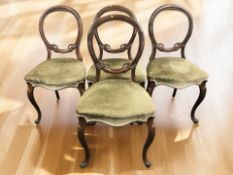A set of four Victorian mahogany balloon back dining chairs.