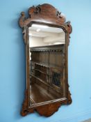 A carved walnut Chippendale-style mirror, height 77 cm.