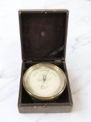 A brass circular barometer signed 'Elliott Brothers, 449 Strand, London', in fitted case.