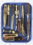 A group of ornamental letter knives, hunting knife, cutthroat razor, a bowie knife,