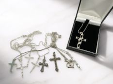 A group of silver necklaces, crucifix pendants,