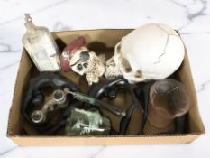 A small box of miscellaneous wares including a pair of opera glasses, replica composition skull,