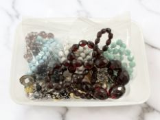 A faceted cherry amber/Bakelite coloured necklace (believed to be simulated),