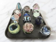 Twelve studio glass paperweights.