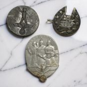 A white metal oriental horse shoe shaped brooch, and two German Third Reich medals.
