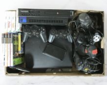 A Sony Playstation 2 and Playstation 3 console, various controllers, joysticks,