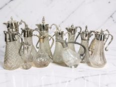 A collection of pressed glass claret jugs.