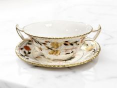 A Royal Crown Derby Imari porcelain twin handled soup bowl and saucer, diameter 17 cm.