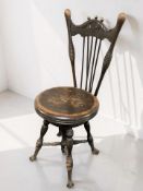 A Victorian beech spindle back chair with revolving seat, raised on claw and ball feet, width 40 cm.
