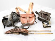 Three leather shotgun cartridge bags, a bandolier and a cleaning rod.