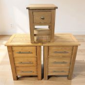 A pair of modern oak and pine three drawer bedside chests, width 50 cm, and a further similar chest.