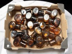 A collection of brown glass bovril jars.