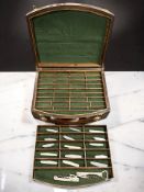 An oak compartmentalised box containing assorted pocket knives and corkscrews.