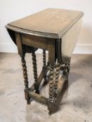 An Edwardian oak gateleg table, width 60 cm.