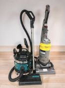 A Dyson upright vacuum and a further vacuum cleaner.