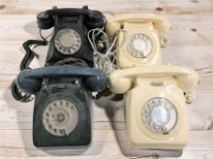 Four plastic rotary telephones.