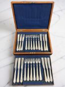 A walnut canteen of EPNS fish cutlery.