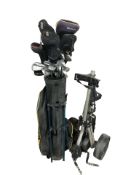 A golf bag containing assorted irons and drivers, and a caddy.