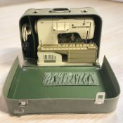 A Bernina electric sewing machine in case.