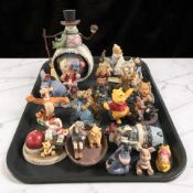 A collection of Winnie the Pooh figurines including Disney, other contemporary ornaments.