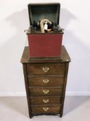 An American cylinder music player and an oak cabinet with five swing-out drawers containing