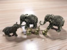 A pair of silvered resin elephant ornaments,