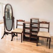 A reproduction mahogany cheval mirror, two wood-effect open bookshelves and a pair of dining chairs.