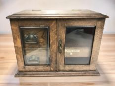 A late Victorian oak smoker's cabinet, width 42 cm.