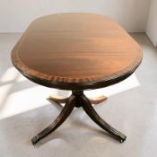 A reproduction inlaid mahogany oval dining table, 150 cm x 90 cm x 75 cm.