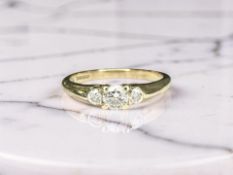 A 9ct yellow gold ring set with three diamonds, size L. CONDITION REPORT: 2.6g.