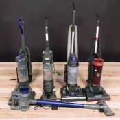 Five assorted vacuum cleaners.