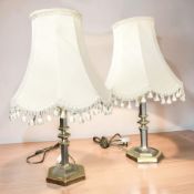 A pair of contemporary brass and silvered metal table lamps, with shades, height 60 cm.