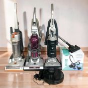 Five various vacuum cleaners.