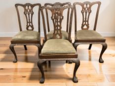 A set of four 20th century carved mahogany dining chairs in the 18th century style on claw and ball