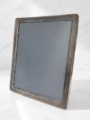 An Elizabeth II silver-mounted easel photograph frame, D R & S, Sheffield 1990, 28.5cm by 23.5cm.