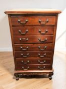 A contemporary eastern hardwood seven drawer chest, 65 cm x 46 cm x 110 cm.