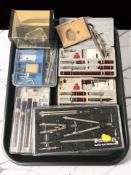 A group of precision drawing sets and similar instruments.