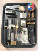 A group of wristwatches, small bronze bust of a boy, hip flask, harmonica, lighters, bank notes,