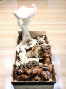 A collection of reproduction cherub figurines and carvings.