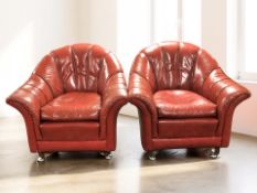 A Tetrad pair of red leather armchairs, width 100 cm.